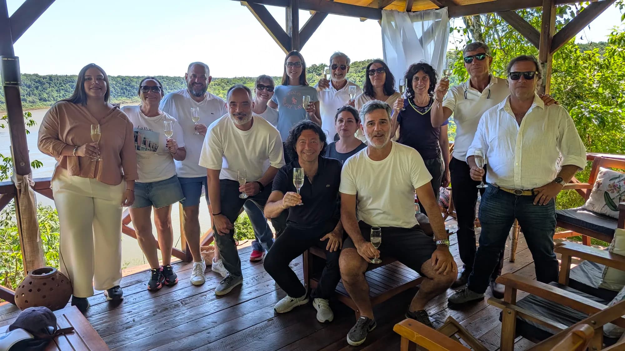A group raising a toast on a riverside deck during an AV Business & Communication experience