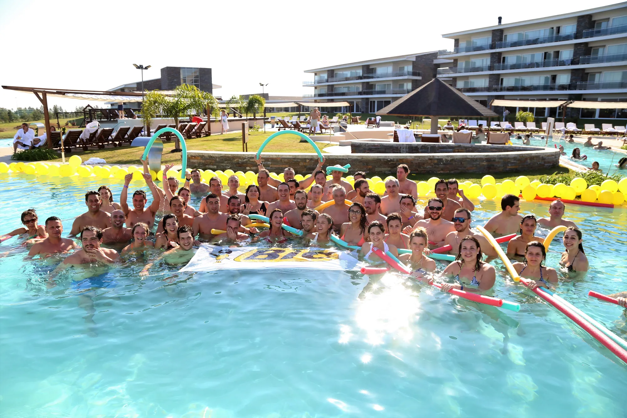 BIC group celebrating in the hotel pool in Arapey, Uruguay, at an AV Business & Communication motivation event