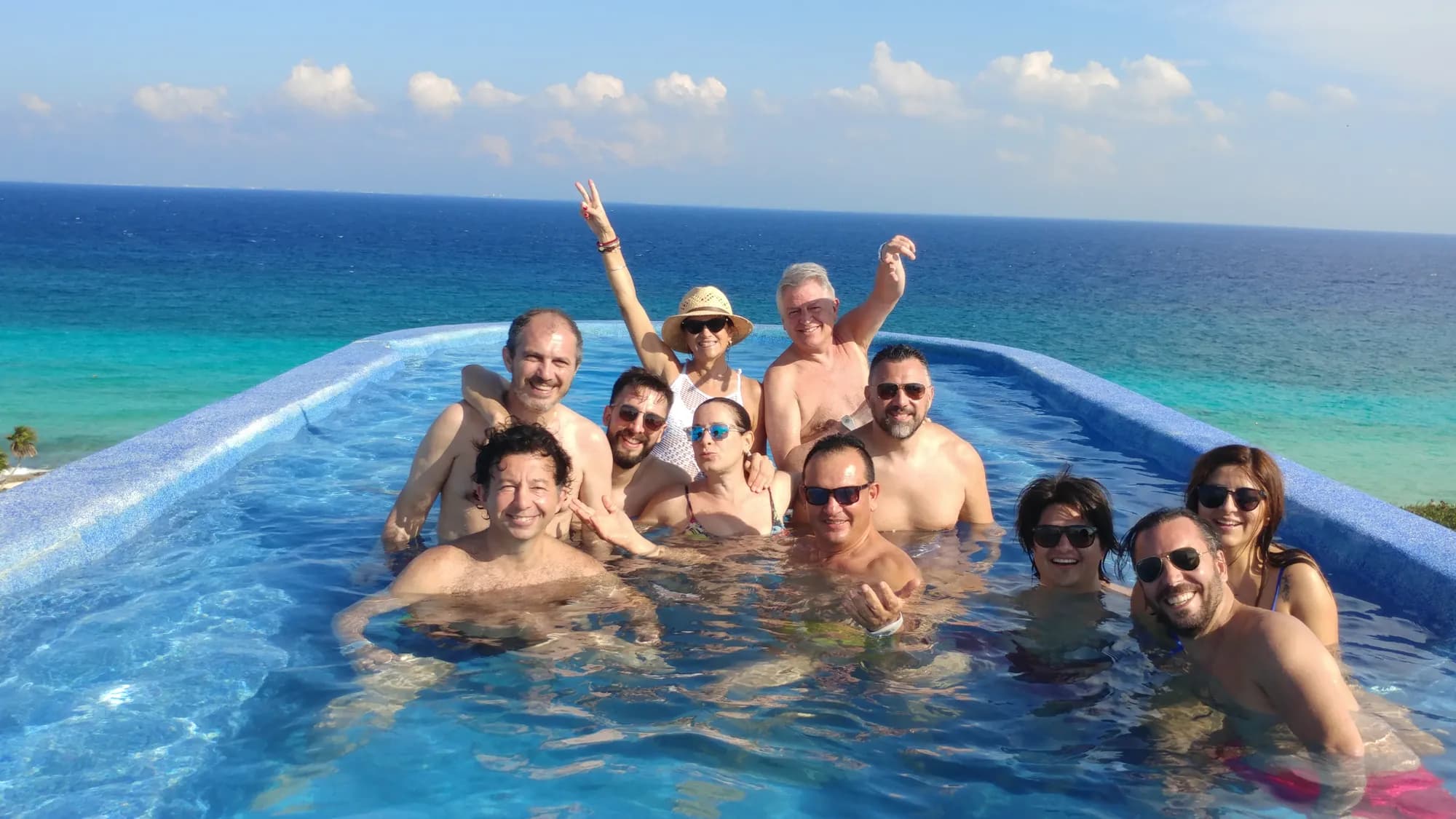 AV Business & Communication incentive travelers in an infinity pool overlooking the sea